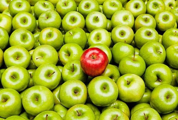 A red apple amidst many green apples indicating how to overcome inconsistency